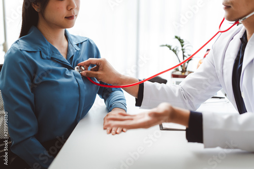 Obraz na plátně Doctor performing medical examination on patient using stethoscope, checking hea