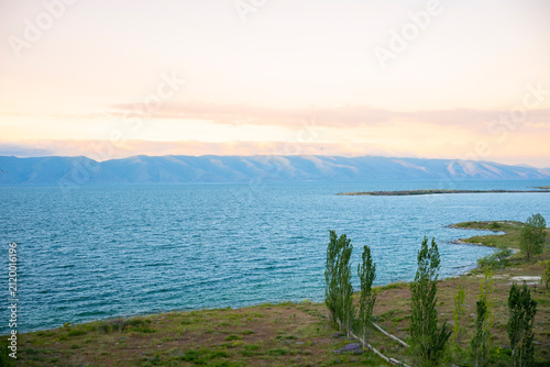 Panoramic View of Blue Lake and Mountain Range with Tall Trees at Sunset

Keywords (50)
