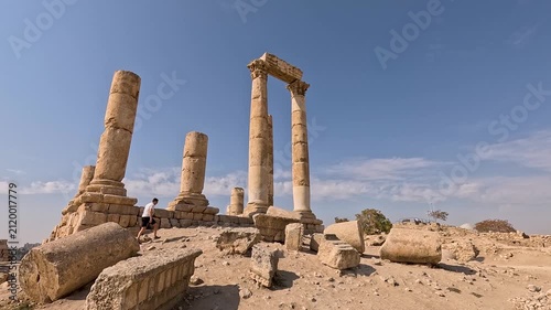 Striking footage of a man wandering through the remarkable ancient ruins at the summit of the Amman Citadel, one of Jordan's most historically significant and breathtaking archaeological sites, Jordan
