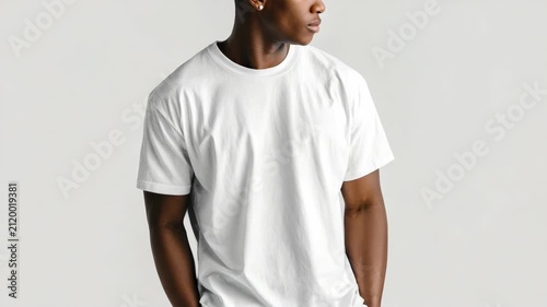 Young Black man wearing plain white t-shirt isolated on white background, studio portrait of stylish male model showing casual clothing for fashion