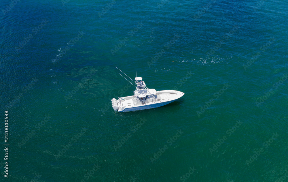 Fototapeta premium Luxury private yacht in sea. Motor yacht luxury vessel. Boat motor aerial. Vacation on summer season. Aerial view motorboat. Yacht boat tour. Luxury boat yachting. Motorboat sailing at sea
