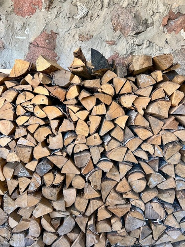 neatly stacked chopped firewood against the wall