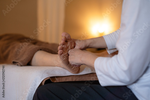 Canvas Print Stock photo of a reflexology session at a salon, focusing on the hands