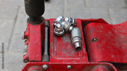 A red car hydraulic lift.