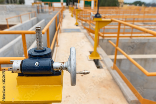 Cuadro en lienzo Close-up shot of manual sluice gate valve and walkway at water treatment plant