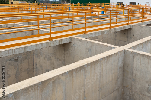 Bild auf Leinwand General view of settling basins and walkways with yellow handrails at water trea