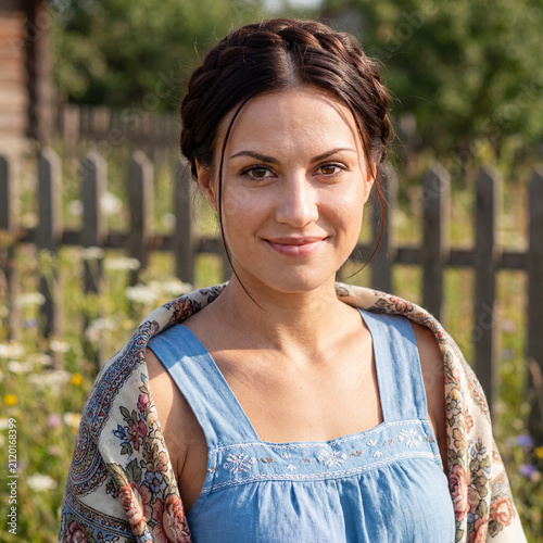 Portrait of a young woman, beautiful village girl in a linen dress