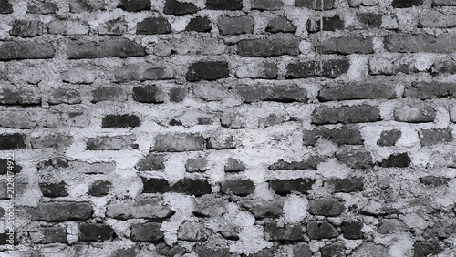 Bild auf Leinwand Black and white unfinished brick wall texture with rough mortar and weathered surface, monochrome construction background for architecture and industrial design