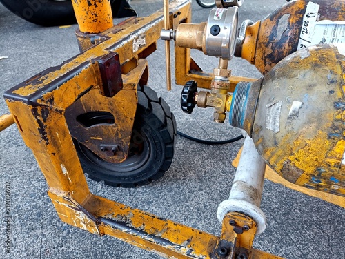 Aircraft tire nitrogen servicing equipment featuring high-pressure nitrogen cylinders and precision pressure regulator mounted on a ground support cart during aviation maintenance