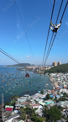 Vertical video of beautiful mediterranean architecture of Sunset Town coastal resort seen from moving cable car cabin on Phu Quoc island Vietnam. Top view.