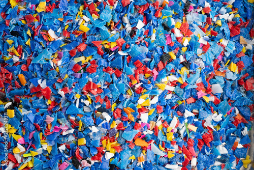 Fotografie Plastic colorful pieces recycling shredded for industrial use.