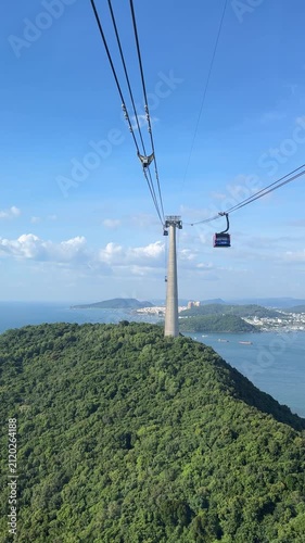 POV vertical video of moving cable car over tropical island island with oncoming cabin. Beautiful seascape background of Phu Quoc island Vietnam.