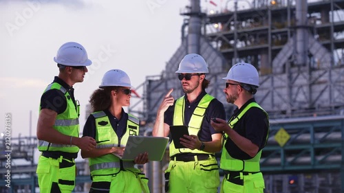 Industrial engineers inspecting an oil and gas refinery, reviewing plant operations and discussing maintenance, safety and energy infrastructure, refinery plant industry factory, Petrochemical plant.