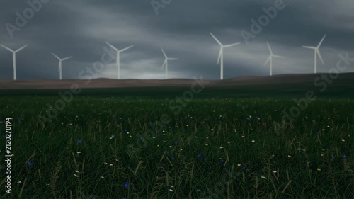 Wind turbines turning on a hill under cloudy sky. Loop animation