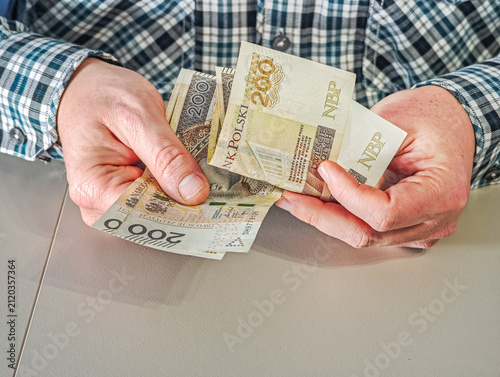 Man holding fan of 200 Polish Zloty banknotes PLN currency, financial success and wealth concept