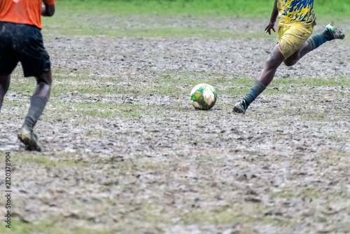 A soccer player kick ball