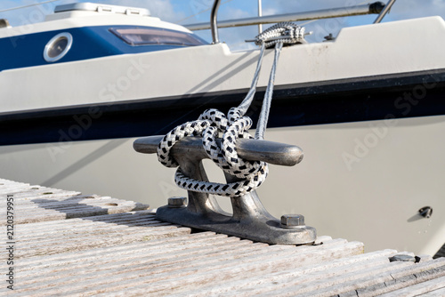 cleat hitch securing a boat line to a metal deck cleat