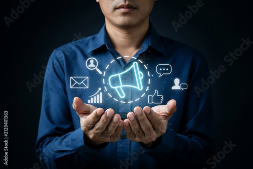 Businessman holding hands with floating digital marketing icons representing social media strategy