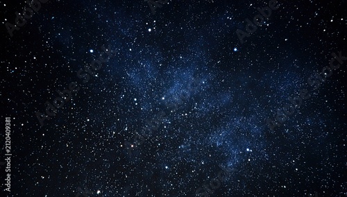Deep, dark expanse filled with countless, twinkling stars and faint cosmic dust clouds