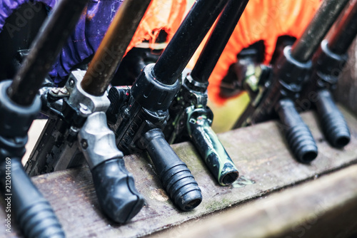 Close up of paintball markers lined up in a row