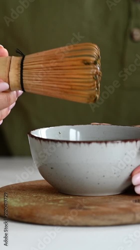 Woman Whisks Matcha Tea With Water