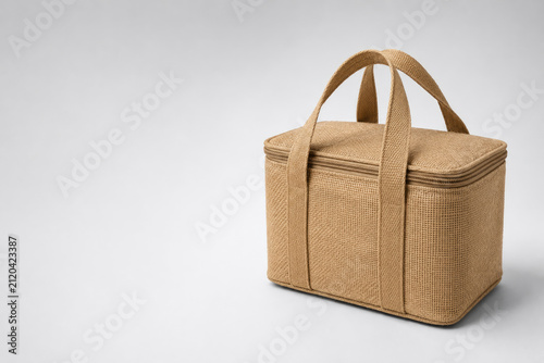 Beige insulated carrier bag with handles. Space for text.