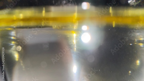 Canvastavla Side view macro close up of golden oil layer floating on water surface tension p