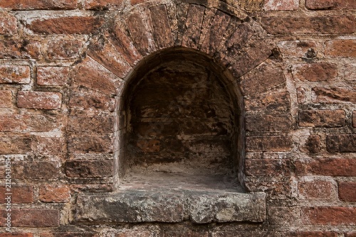 Brick alcove recessed niche in weathered masonry wall