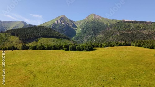 Aerial footage of the Belianske Tatry in Slovakia, featuring the mountain peaks Zdiarska Vidla and Havran. The view captures the dramatic ridgelines, rocky slopes and green alpine landscape
