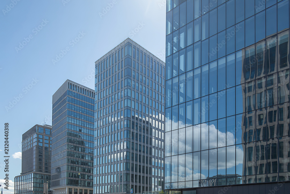 Fototapeta premium Glass skyscrapers with reflective windows against a clear blue sky