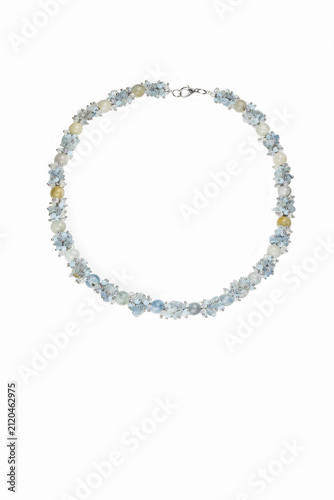 Women's beaded necklace with white and blue flowers on a white background.