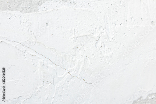 White plaster texture on concrete wall background, rough cement surface with filler.