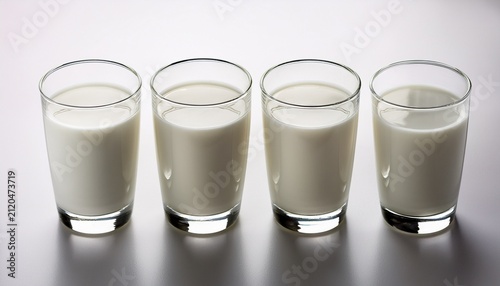 Four Glasses Of Fresh Milk On A White Background