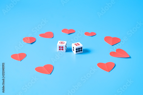 Dice game with mini red hearts on background.