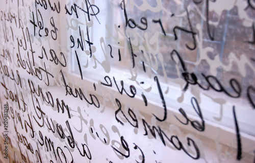 Writing on glass shows thoughts and ideas in a quiet room during daylight hours