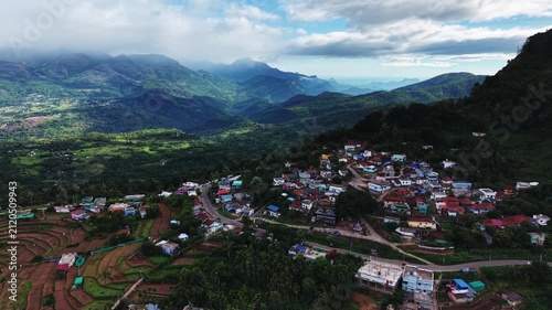 Aerial view of a hill town surrounded by green mountains in Kerala, India