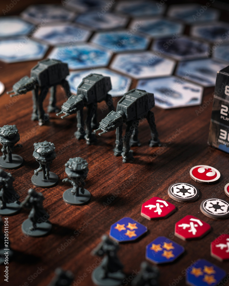 Fototapeta premium Imperial army miniatures assembled on a Battle of Hoth tabletop battlefield featuring AT AT walkers, scout droids and infantry captured with dramatic lighting in a cinematic perspective