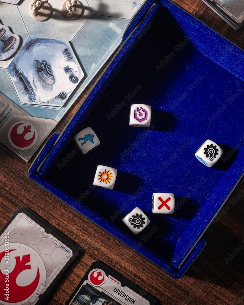 Fototapeta premium Dice arranged on a gaming mat in an overhead composition surrounded by Battle of Hoth game pieces and the Rebel symbol highlighting tabletop strategy and science fiction gameplay