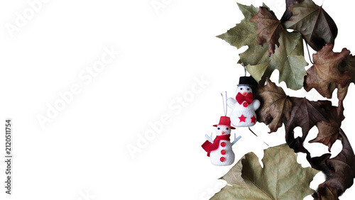 Snowman christmas ornaments with autumn leaves border creating a seasonal transition, transparent background