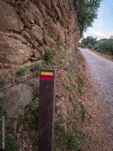 Trail waymarkers guiding hikers along the Sao Mamede de Ribatua route in Alijo, Portugal. Scenic boardwalks and gravel paths near the Tua River in the Douro Valley.