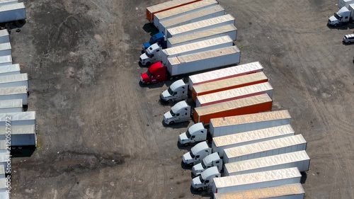Aerial view of semi trucks parked at a truck stop depot.