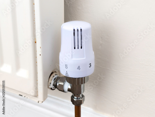Modern White Thermostatic Radiator Valve (TRV) on Domestic Home Heating Radiator