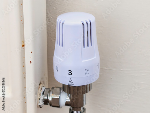 Modern White Thermostatic Radiator Valve (TRV) on Domestic Home Heating Radiator