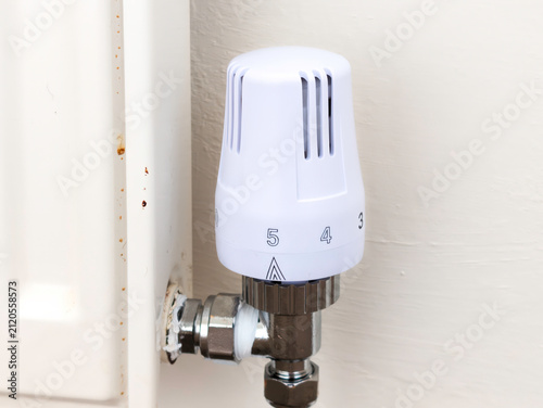 Modern White Thermostatic Radiator Valve (TRV) on Domestic Home Heating Radiator