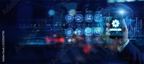 Operations chief holding a mobile phone analyzing global Work In Progress data on a holographic world map. Futuristic technology, secure network connections, and advanced data visualization.