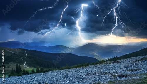 electric stormy night with lightning over mountains