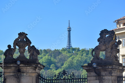View of the Petrin Tower from the courtyard of Prague Castle with sculptures on the Gate of the Giants. Hradcany district