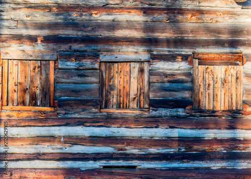 Vintage rustic wooden wall with closed shutters