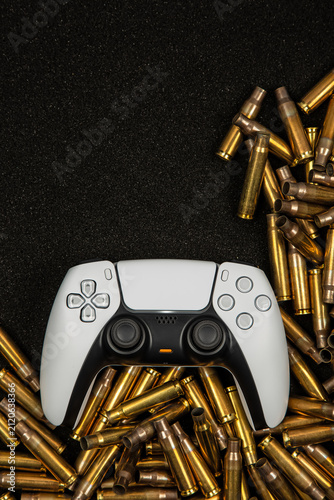 Fotografía White gamepad on bullet shell casings