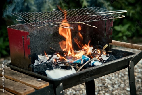 Foto Flames and Charcoal Burning inside Portable Outdoor Barbecue Grill